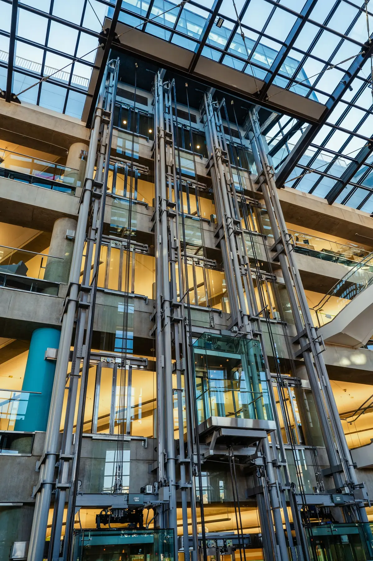 Sample image: steel-framed glass lift shaft with exposed guide rails